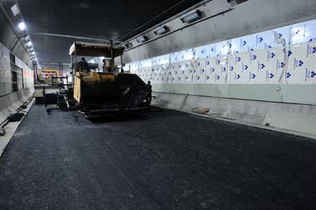 A bulldozer runs in a newly completed tunnel under the Yangtze river in Wuhan, capital of central China's Hubei Province, Dec. 24, 2008.