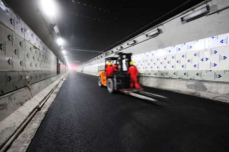 A bulldozer runs in a newly completed tunnel under the Yangtze river in Wuhan, capital of central China's Hubei Province, Dec. 24, 2008. 