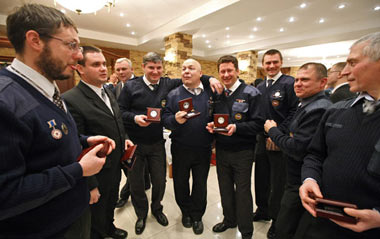 Staff of Russia's Ministry of Emergency Situations celebrate after receiving souvenir badges in Moscow on December 24, 2008.