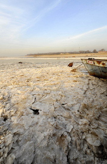 Ice and slush moves past a float bridge at the Jinan section of the Yellow River in Jinan, east China's Shandong Province December 23, 2008. [Xinhua]