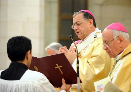 Latin Patriarch of Jerusalem Fouad Twal leads the midnight mass in St. Catherine's Catholic Church which connects with the Church of Nativity in the West Bank city of Bethlehem Dec. 24, 2008. [Yin Bogu/Xinhua]