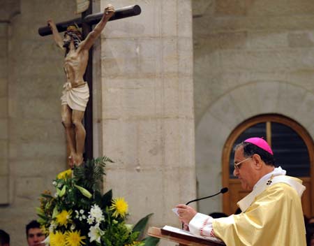 Latin Patriarch of Jerusalem Fouad Twal leads the midnight mass in St. Catherine's Catholic Church which connects with the Church of Nativity in the West Bank city of Bethlehem Dec. 24, 2008. [Yin Bogu/Xinhua]