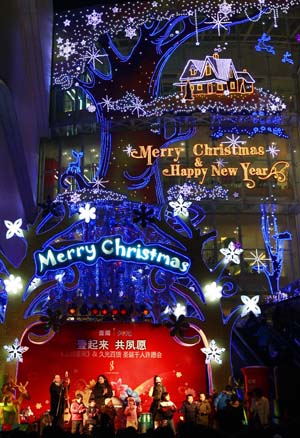 People gather at a square that is illuminated by Christmas lights in downtown Shanghai Dec. 24, 2008.[Pei Xin/Xinhua] 