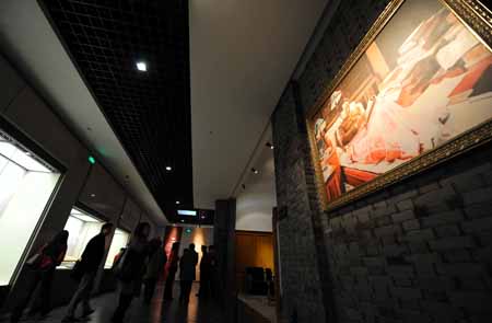 Visitors look at a picture in the Mao Zedong Relic Museum in Shaoshan Village, the birthplace of late Chinese leader Mao Zedong, in Xiangtan City of central China&apos;s Hunan Province, Dec. 25, 2008. [Xinhua]