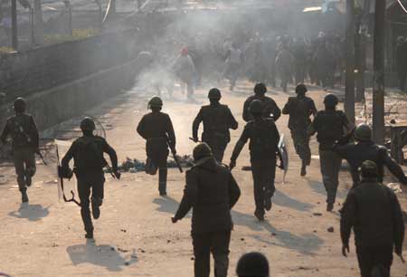  Indian paramilitary soldiers chase Kashmiri Muslim protesters during a protest in Srinagar, summer capital of Indian controlled Kashmir, Dec. 26, 2008.