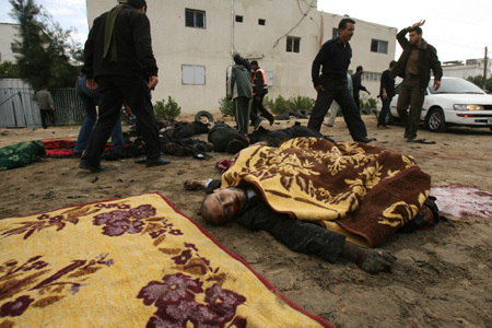 Bodies of Palestinian Hamas policemen are scattered on the ground following an Israeli air strike in Gaza City on December 27, 2008. About 200 Palestinians were killed and hundreds wounded in a series of simultaneous Israeli air strikes in Gaza Strip. (Xinhua photo] 