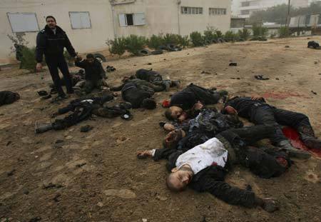 Bodies of Palestinian Hamas policemen are scattered on the ground following an Israeli air strike in Gaza City on December 27, 2008. About 200 Palestinians were killed and hundreds wounded in a series of simultaneous Israeli air strikes in Gaza Strip. (Xinhua photo)