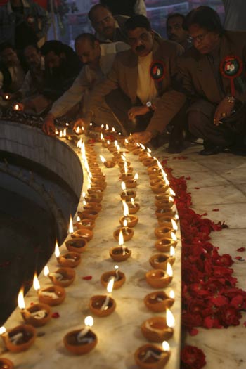 Supporters light oil lamps during a prayer ceremony ahead of slain former prime minister Benazir Bhutto's first death anniversary in Lahore.[Xinhua/Reuters]