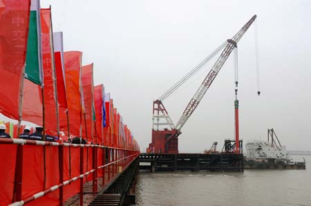 A crane drive piles as the construction of the No.4 Cross Yangtze River Bridge started in Nanjing, capital of east China's Jiangsu Province, Dec. 28, 2008. The 28.996-km-long bridge has a span of 5.448 km, the longest in China and the third longest in the world. The No. 4 bridge is scheduled to be completed in 2010 and put into operation in 2013. (Xinhua/Sun Can) [Sun Can/Xinhua]