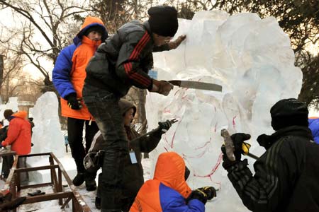 Participants create an ice work during an ice-carving contest for college students in Harbin, capital of northeast China's Heilongjiang Province, Dec. 28, 2008.[Zengshuang/Xinhua]