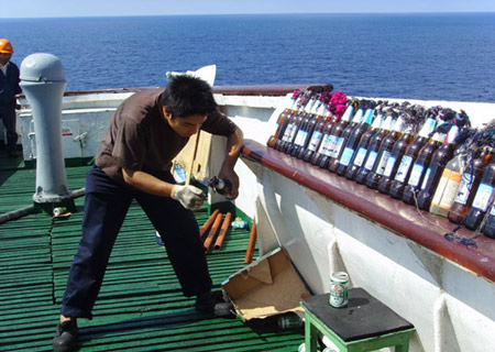 A sailor is ready to defend from pirates' attacks on the deck of the Chinese ship 'Zhenhua 4' in the Gulf of Aden, on Dec. 17, 2008. 