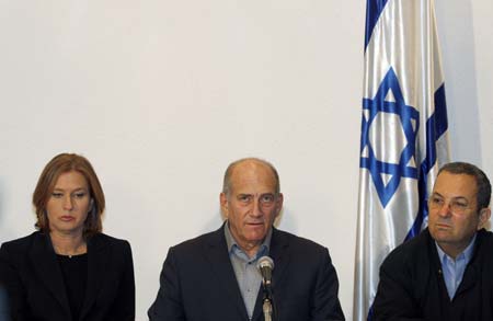 Israel's Prime Minister Ehud Olmert, Defence Minister Ehud Barak (R) and Foreign Minister Tzipi Livni (L) hold a news conference in Tel Aviv December 27, 2008.