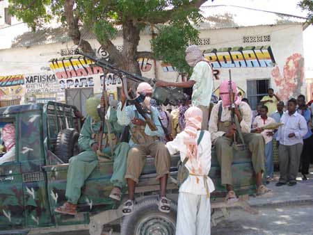 Fighters of Islamist Al-Shabaab movement, a major rebel group in Somalia, display a battle wagon which they say defected from the government forces, in Mogadishu, captial of Somalia, Dec. 27, 2008. [Xinhua] 