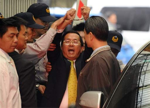 Former Taiwan leader Chen Shui-bian shouts 'Witch hunt!' and 'Go Taiwan!' while holding up his handcuffed hands as he is taken into custody on Nov. 12. He is under investigation for money laundering and taking bribes during his eight year tenure that ended in May. Chen has denied the charges against him, saying he is being persecuted by Ma Ying-jeou's new government. 