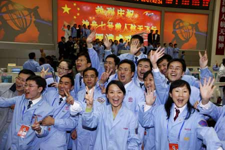 Personnels involved in China's manned spaceflight mission cheer up at Beijing Space Command and Control Center in Beijing, capital of China, on Sept. 28, 2008 to celebrate China's Shenzhou-7 spacecraft's successful spacewalk mission.[Xinhua]
