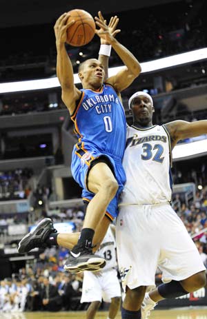 Russell Westbrook (L) of Oklahoma City Thunder goes to the basket during the NBA basket games against Washington Wizards in Washington, the United States, Dec. 27, 2008.