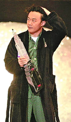 Eason Chan, wearing pajamas, receives one of his five awards at the 'Metro Radio Hit Awards 2008' ceremony on December 26, 2008 in Hong Kong.