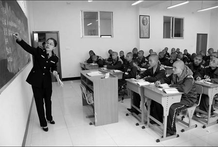 Juvenile prisoners attend class in a prison in Changsha, capital of Hunan province. [China Daily]