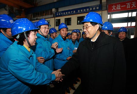 Chinese President Hu Jintao (R Front) shakes hands with a woman as he visits workers and inspects production at Dongfang Steam Turbine Works in Hanwang Township of Mianzhu City, southwest China's Sichuan Province, Dec. 28, 2008. President Hu Jintao visited quake-hit Sichuan Province on Dec. 27-29, showing concern for survivors and inspecting reconstruction work. [Ju Peng/Xinhua] 