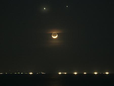 A rare positioning of planets Venus (top left) and Jupiter (top right) and the crescent moon of the Earth provides a 'smiley' effect that captivated Asia Monday night Dec. 1, 2008 in Manila, Philppines. The heavens smiled down on Earth December 1 in National Geographic News's most viewed space photo of 2008. [Photo: NASA]