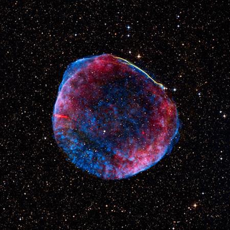 The remnant of a supernova called SN 1006 hangs like a gumball 7,000 light-years away in a composite image released by NASA on June 26, 2008. The blast wave from the stellar explosion is still traveling at about 6 million miles (9.6 million kilometers) an hour, heating gases along its path that emit radiation in visible light. [Photo: NASA]