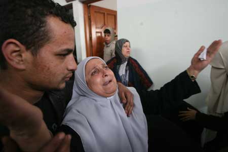  A relative of the five siblings killed in an Israeli air strike in the Jabalia refugee camp in Gaza Strip, cries during the funeral on Dec. 29, 2008. The five girls from the Baalusha family were killed in an Israeli air raid that targeted a mosque near their home in Jabalia, medics said. [Xinhua]