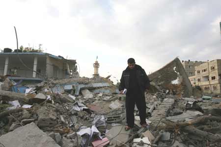 A Palestinian stands on the wreckage of a mosque damaged by Israeli airstrike, at the Jabalia refugee camp in Gaza Strip, Dec. 29, 2008. Over 345 Palestinians were killed and some 1600 wounded, due to Israeli military operation, according to the rescue department in Gaza. [Xinhua] 