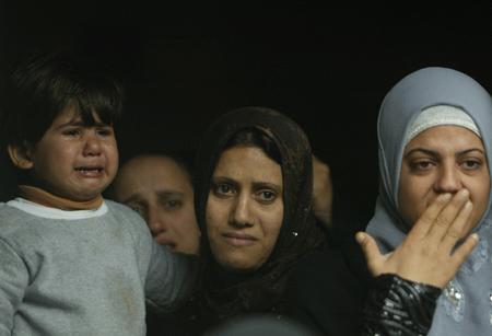  Palestinians gather during a funeral of two girls -- Lama and Haya Hamdan, who were killed in Israeli airstrikes, in northern Gaza Strip town of Beit Hanoun on Dec. 30, 2008.[Xinhua]