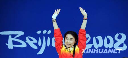 Chinese diver Guo Jingjing waves to spactators during the awarding ceremony of women's 3m springboard at the Beijing 2008 Olympic Games in the National Aquatics Center, also known as the Water Cube in Beijing, China, Aug. 17, 2008. Guo won the gold medal in the event with a score of 415.35 points.