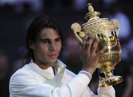 Rafael Nadal of Spain holds his trophy after defeating Roger Federer of Switzerland in their finals match at the Wimbledon tennis championships in London July 6, 2008.