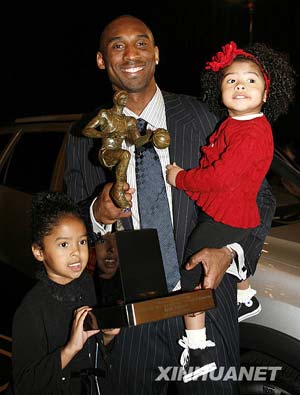 Los Angeles Lakers guard Kobe Bryant stands with his daughter Natalia (L) and holds his other daughter Gianna along with the Maurice Podoloff Trophy after being named the NBA's Most Valuable Player (MVP) during a presentation in Los Angeles, California May 6, 2008. Bryant, long regarded as one of the basketball league's top players, wins the award for the first time in his 12-year NBA career. 