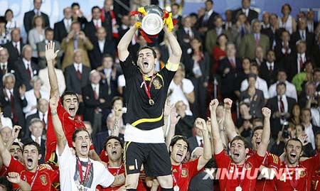 Spain's Iker Casillas holds up the trophy as he celebrates with teammates after their Euro 2008 final soccer match victory over Germany at the Ernst Happel stadium in Vienna, in this June 29, 2008 file photo. 