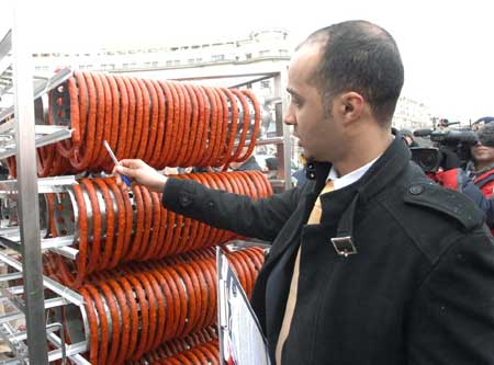 A sausage looped around a rack is seen in Bucharest during a Guinness World Record event for the world's longest sausage Dec. 27, 2008. 