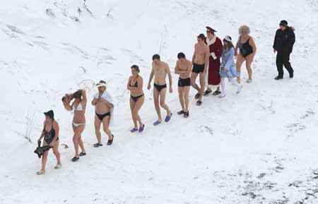 Members of a local ice swimming club head for the water to swim in the Yenisey river in the Siberian city of Krasnoyarsk Dec. 28, 2008. The club promotes a healthy life style, encouraging its members to spend most of their free time in the countryside. 