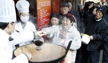 Citizens queue in line for 'Laba Porridge' outside a time-honored pharmacy in Shanghai, China, Jan. 3, 2009. 