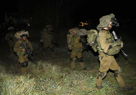 Israeli soldiers advance near the border with northern Gaza during a ground operation by the Israeli army late January 3, 2009. 