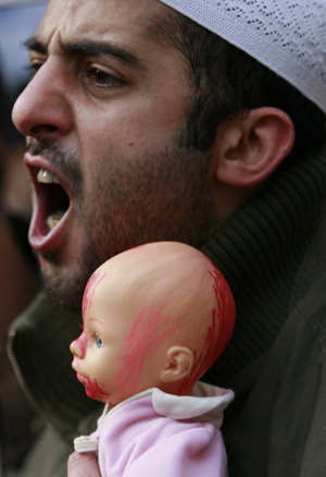 A pro-Palestinian protester holds a doll painted red, during a rally outside Israel's embassy in Athens January 3, 2009.