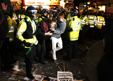 A bleeding pro-Palestinian demonstrator is escorted by police during a protest in response to the Israeli air strikes on Gaza near the Israeli Embassy in London January 3, 2009.