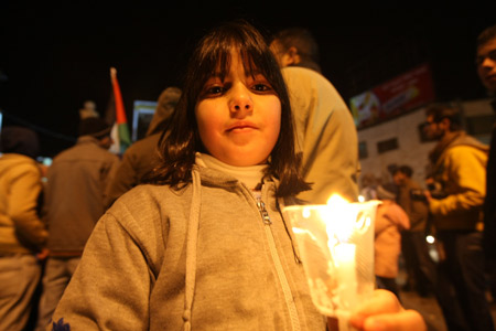 A Palestinian girl holds a candle at a demonstration in downtown Ramallah against Israel's ground operation on the Gaza Strip, Jan 3, 2009. 