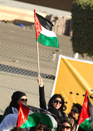 A Kuwaiti woman waves a Palestinian national flag during a demonstration to protest against Israel's continued airstrikes on the Palestinians in the Gaza Strip, in Kuwait City, capital of Kuwait, Jan. 3, 2008. 