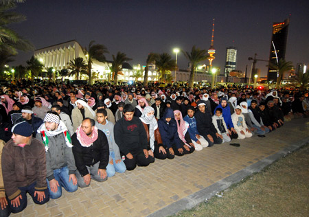 People pray for Palestinians during a demonstration to protest against Israel's continued airstrikes on the Palestinians in the Gaza Strip, in Kuwait City, Kuwait, Jan. 3, 2008. 