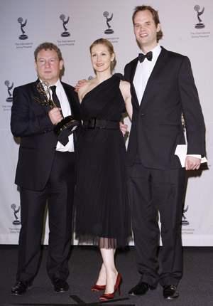 British duo Ashley Pharoah (L) and Cameron Roach (R) celebrate with presenter Kelly Rutherford after winning best Drama Series at the 36th International Emmy Awards Gala in New York, Nov. 24, 2008. Rutherford and her husband of two years, German entrepreneur Daniel Giersch, are asking for a divorce.