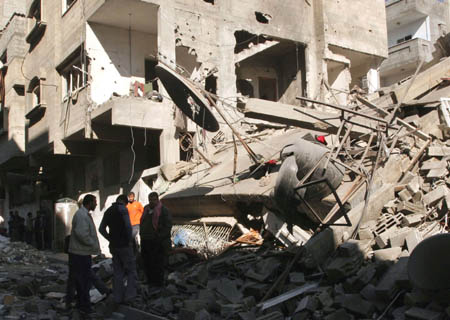 Palestinians inspect a destroyed house following an Israeli air strike in Gaza City on Jan. 3, 2009. 