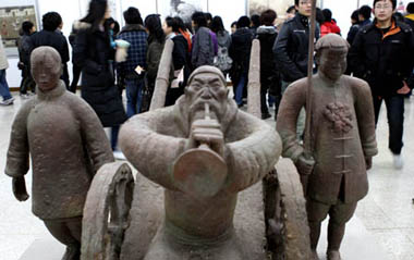 The visitors view a sculpture presented on the Fine Arts Exhibition of the Yangtze River Delta Region memorizing the 30th Anniversary of China's reforms and opening up campaign, in Hangzhou, capital of east China's Zhejiang Province, Jan. 3, 2009.