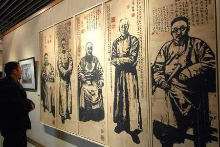 A visitor views some scratchboards presented on the Fine Arts Exhibition of the Yangtze River Delta Region memorizing the 30th Anniversary of China's reforms and opening up campaign, in Hangzhou, capital of east China's Zhejiang Province, Jan. 3, 2009. [Cheng Ruixin/Xinhua]