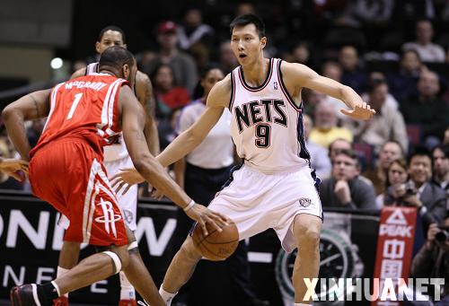 Yi is defending Tracy Mcgrady in the second half of their NBA basketball game in East Rutherford, New Jersey December 22, 2008.