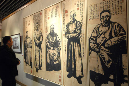 A visitor views some scratchboards presented on the Fine Arts Exhibition of the Yangtze River Delta Region memorizing the 30th Anniversary of China's reforms and opening up campaign, in Hangzhou, capital of east China's Zhejiang Province, Jan. 3, 2009. (Xinhua/Cheng Ruixin) 