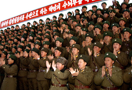 Soldiers clap hands to welcome Kim Jong Il, top leader of the Democratic People's Republic of Korea (DPRK), in this undated picture released by Korean Central News Agency (KCNA) on Jan. 5, 2009. [Xinhua]