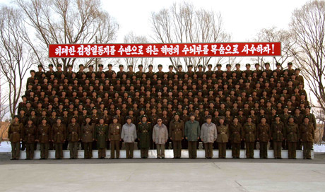 Kim Jong Il (C, front), top leader of the Democratic People's Republic of Korea (DPRK), has a group photo taken when inspecting Unit 1489 under the Artillery Command of the Korean People's Army (KPA) in this picture released by Korean Central News Agency of DPRK. [Xinhua]