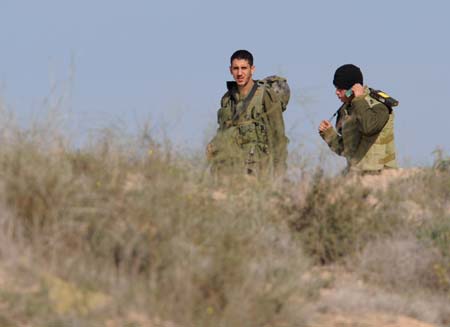 Israeli troops patrol in the northern Gaza Strip Jan. 5, 2009. Israel continued on Monday its military attacks on the Palestinians in the Gaza Strip since the start on Dec. 27, 2008, leaving at least 514 people dead and 2,600 others wounded. [Yin Bogu/Xinhua] 